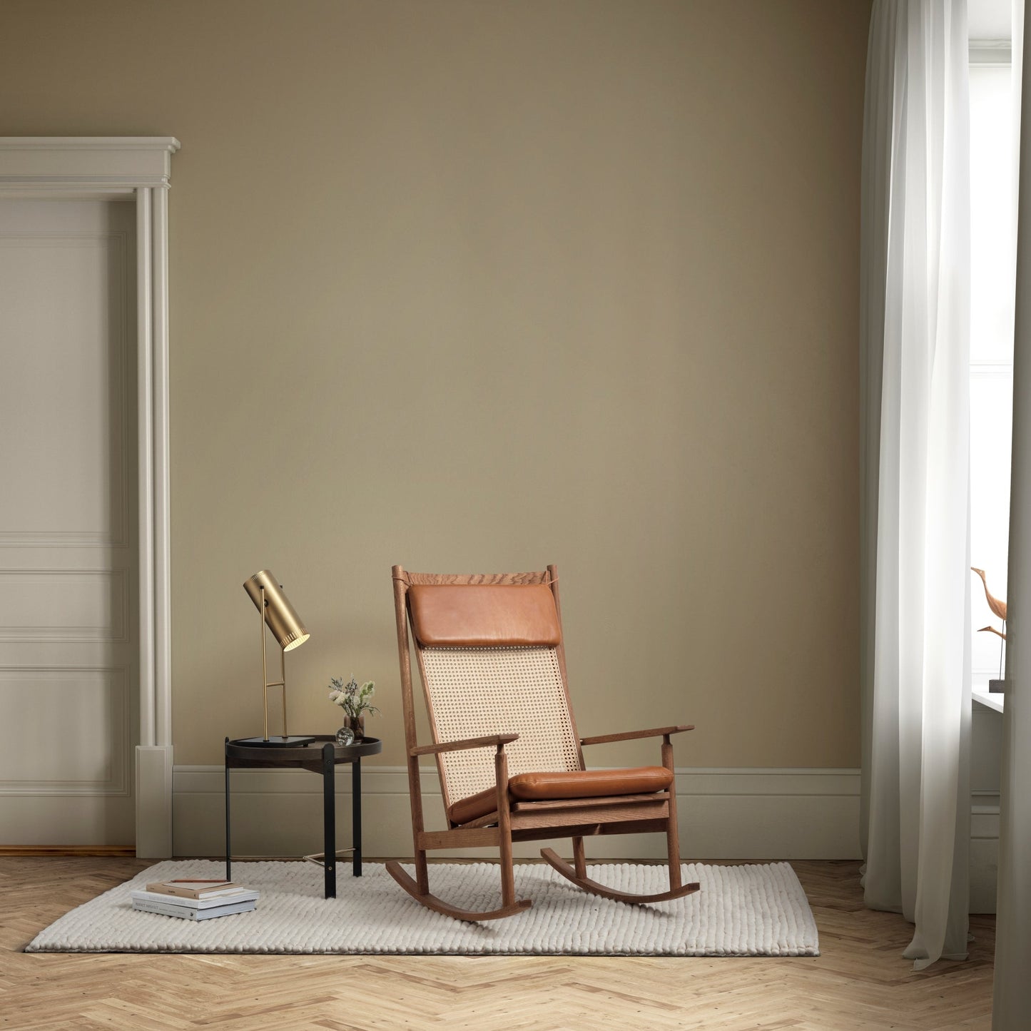 Rustic rocking chair in a room with beige walls and wooden flooring.