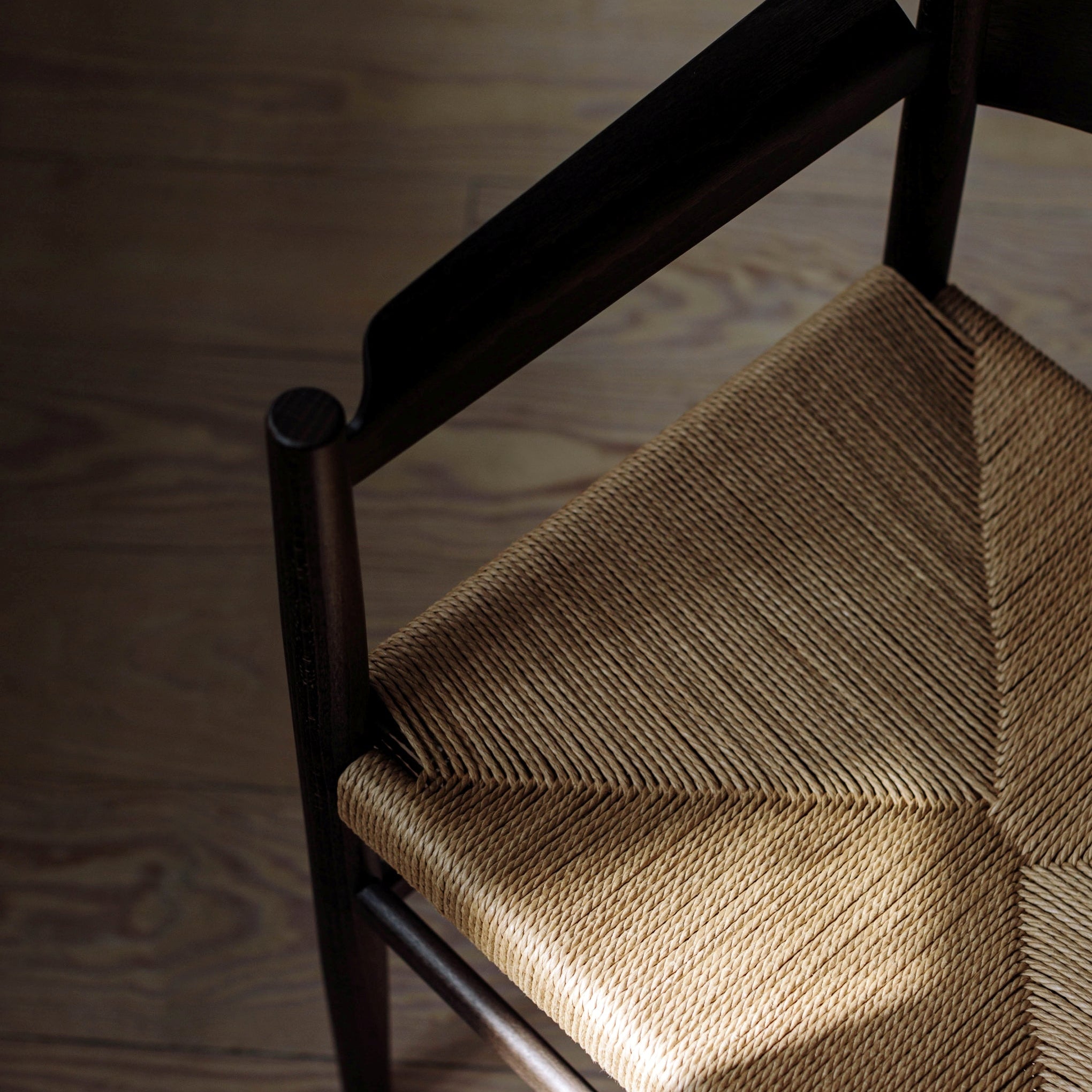 Wooden chair with a woven seat on a wooden floor